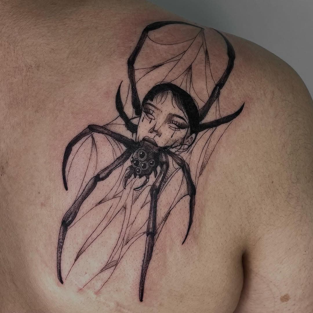 Black-and-grey surreal spider with a woman's face and web on the shoulder by AinsleyXTattoos
